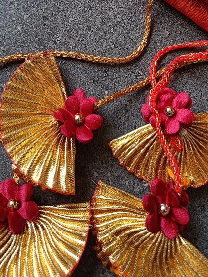 A close-up of the delicate, fan-shaped paper tassels we use to adorn our traditional wedding scrolls, adding a touch of handmade artistry.