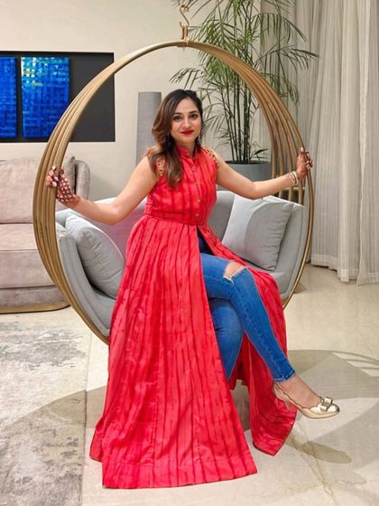 Our client Mansi looking festive in a vibrant red pleated long-line top with an embellished collar, styled as a modern Indo-western look with jeans.