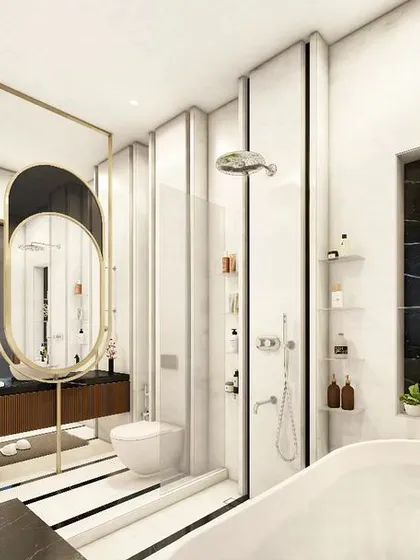 A wider view of the luxury washroom, showing the freestanding bathtub and the spacious layout. The design seamlessly integrates the vanity, toilet, and shower areas, using consistent materials like marble, wood, and brass for a cohesive look.