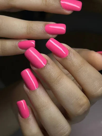 A bold, hot pink manicure on square-shaped extensions. This vibrant color is full of energy and perfect for making a statement.