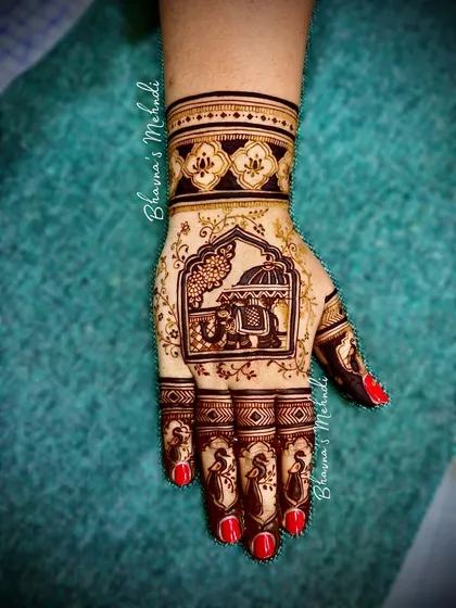 A close-up of a hand with a doli scene inside a jharokha, a classic and beloved wedding motif.