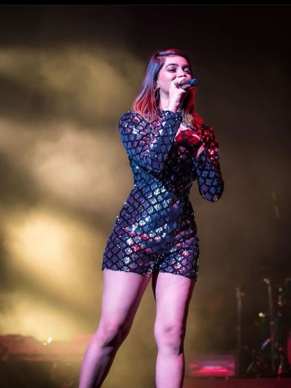 A powerful shot from a live concert, feeling the music in a sequined romper. This is me, happy and at home on the stage.