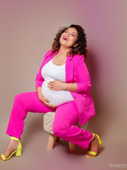 Pure joy! This laughing portrait is infectious. It shows that maternity shoots can be fun, energetic, and full of personality.