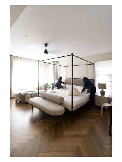 A behind-the-scenes shot of our team adding the final touches to the master bed, ensuring every detail is perfect.