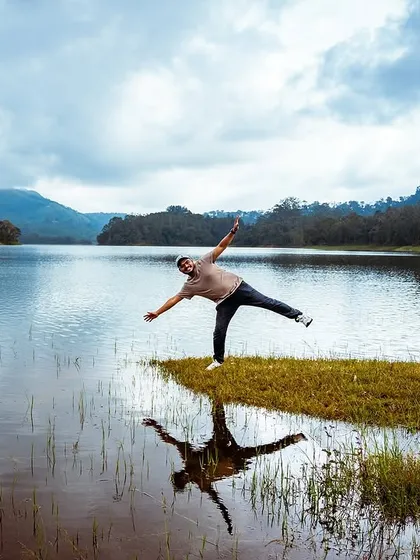 A moment of playful balance by a serene lake in Munnar. I encourage my groups to have fun and create their own unique memories.