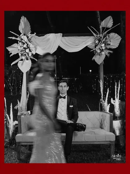 An artistic shot using motion blur, capturing the bride in movement while the groom sits in focus, creating a dynamic and modern portrait.