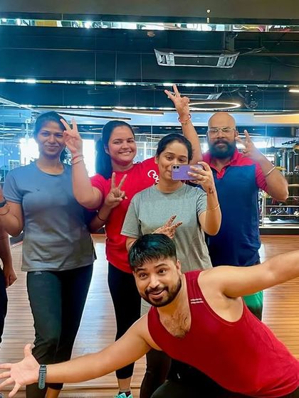 All smiles and victory signs with our fantastic group at Gold's Gym. You can see the joy and energy that fills our studio after a great workout.
