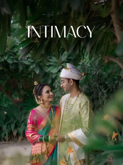 An intimate portrait of the couple sharing a look of love, framed by the green leaves of their outdoor wedding venue.