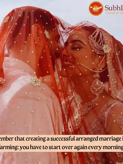 A candid moment of laughter between a bride and groom, seen through her red veil. We help find partners who bring this kind of joy and lightness to your life.