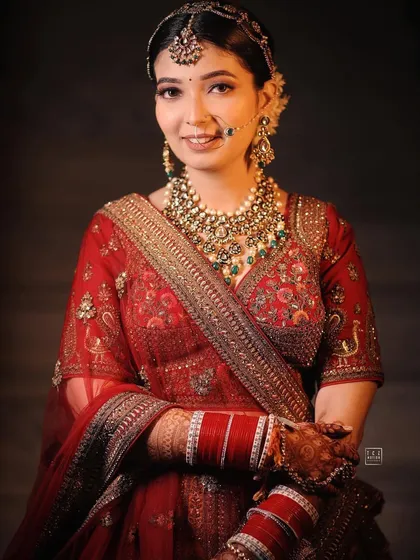 A smiling portrait of the bride, looking radiant and happy. The traditional jewellery adds to her timeless beauty.