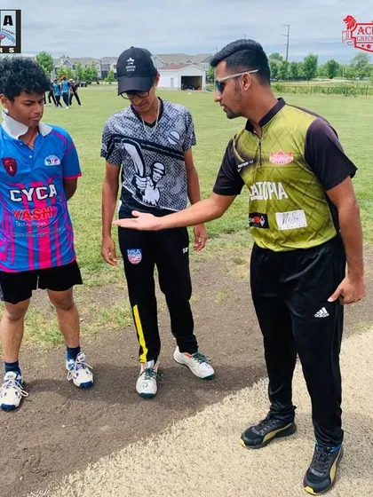 Our coaches discussing strategy and technique with CYCA players on the pitch in Chicago. This direct interaction is crucial for player development.