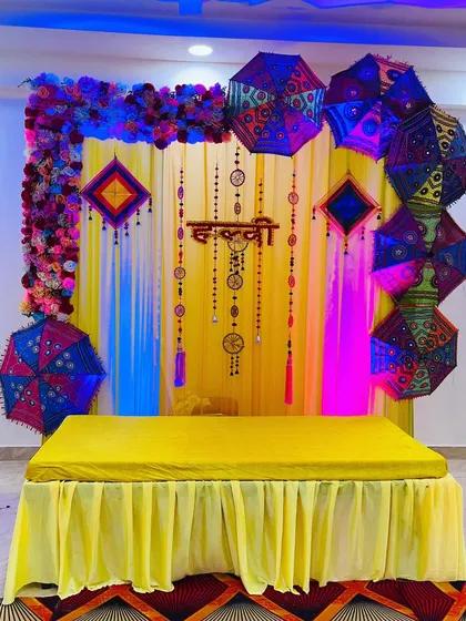 The same Haldi setup seen with different lighting. I can add simple colored lights to change the mood of the decor for evening functions.
