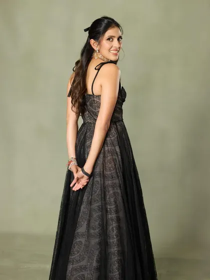 This black Giambattista Valli gown is the epitome of effortless grace. The layered tulle and simple spaghetti strap top create a timeless and romantic look.