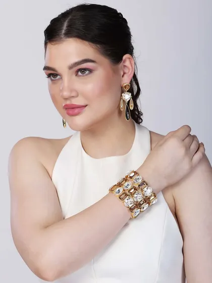 This image provides a clear view of a modern, oversized crystal cuff bracelet. The model's pose is designed to make the bracelet the central focus, perfect for a product feature in a digital catalogue.