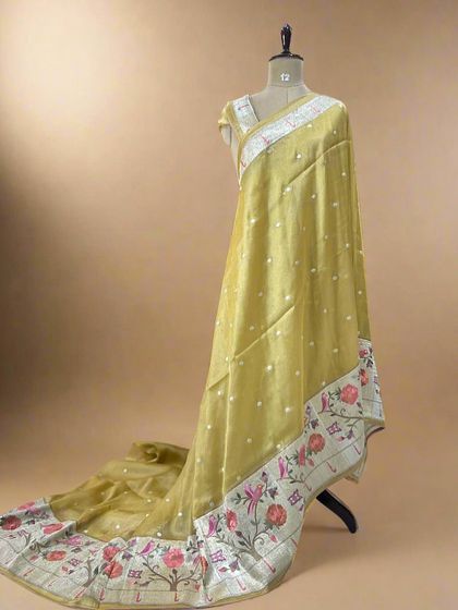A mustard-toned tissue saree with a vibrant Paithani border, perfect for a festive, traditional look.