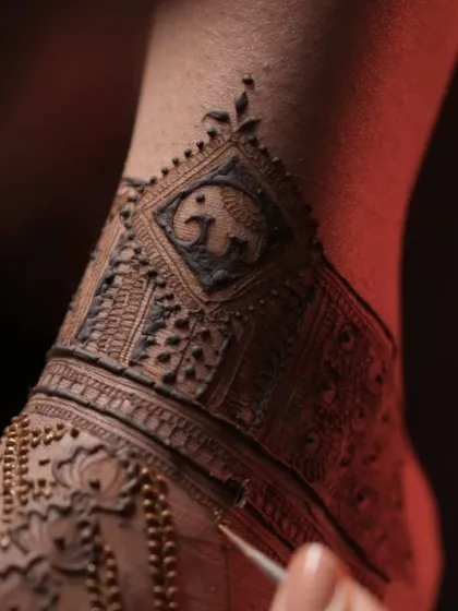 A detailed close-up of the elephant motif on the ankle. These small, personal touches are what make a design truly special and unique to the bride.