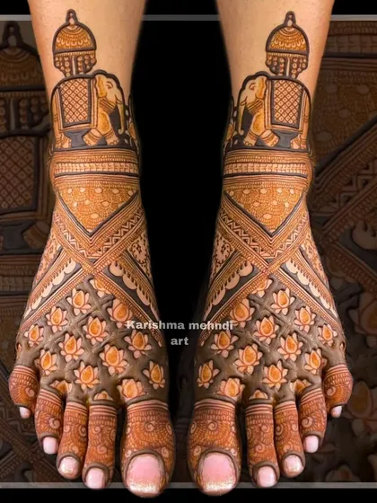 An example of my detailed bridal feet mehendi, ensuring beauty from head to toe. This design features a dense pattern of lotus flowers across the top of the feet, complemented by elephant motifs and geometric patterns for a balanced and elegant finish.