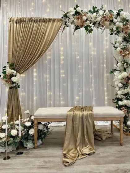 For a more elegant and sophisticated look, I created this stage with a white and gold theme. The setup includes a floral arch, soft drapery with fairy lights, and candle accents for a truly romantic feel.