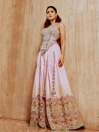 This pastel-embroidered lehenga on Nushrratt Bharuccha is a work of art. The corset-style top and detailed floral embroidery make it a standout piece for any wedding event.