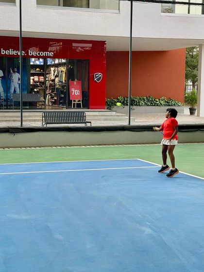 A young player in our Red Ball program focuses on the ball during a match. Even at this early stage, we teach the importance of concentration and footwork.