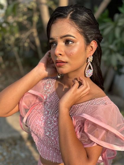 A graceful pose showing off the beautiful makeup.