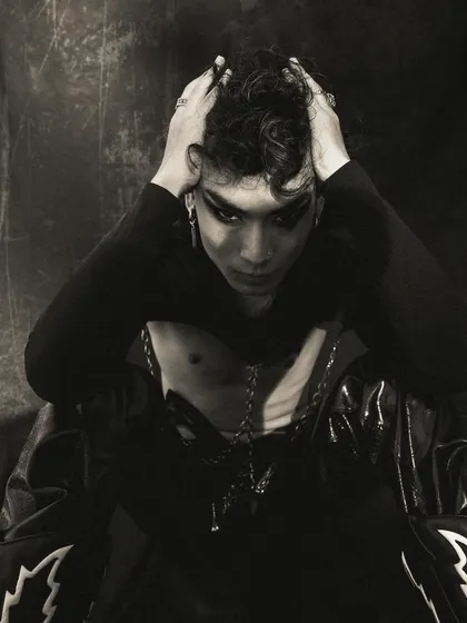 A portrait capturing a moment of angst or frustration. The model's hands in his hair and the dark, moody lighting create a powerful, emotional narrative.