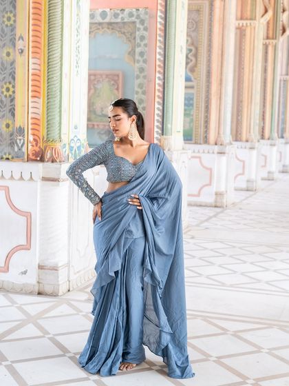 Feeling fine in this dusty blue pre-draped saree with a sequin blouse. A modern and chic look for any event.