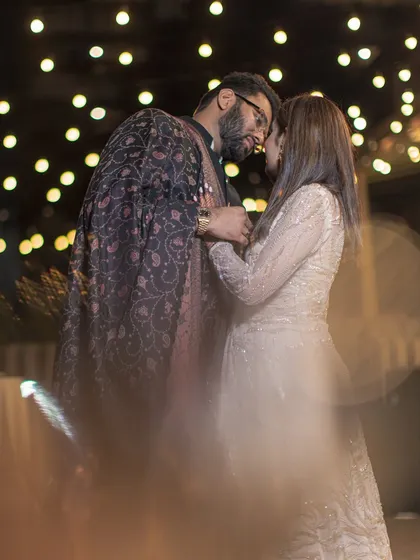 A dreamy and romantic portrait of the couple, shot with a creative blur effect and beautiful bokeh from the background lights.