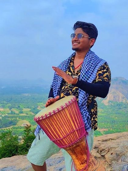 Spreading joy and rhythm with a djembe on the Ramanagara hills. Our treks are not just about silent walking; they are also about celebrating life, sharing positive energy, and finding happiness in simple moments together.