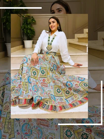 Here I am in one of my favorite Indo-Western pieces. This printed lehenga skirt paired with a classic white shirt is perfect for a sangeet or mehendi. It’s a great example of how you can create a unique, stylish look from my collection.