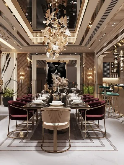 Imagine dining in a work of art. This luxurious dining area captivates with rich maroon chairs, a modern chandelier against a mirrored ceiling, and a stylish partition that defines the space with glamour.