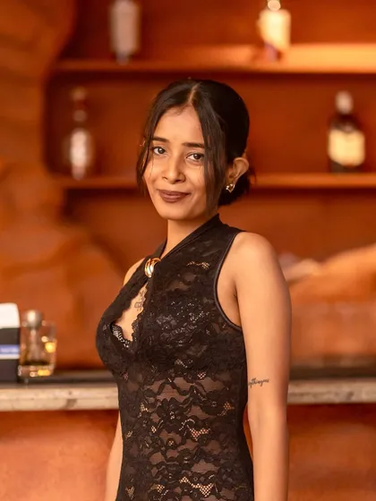 A guest smiling for the camera at the bar. It's all about creating a fun and welcoming atmosphere.