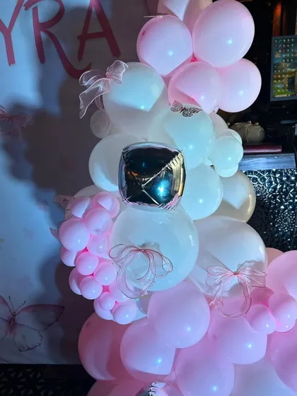 Detail shot of the balloon arrangement, showing the mix of pink and white balloons with small silver cube accents for a touch of sparkle.