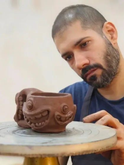 This student is creating a whimsical mug with a fun, toothy grin. We encourage our students to bring their imagination to their work, creating pieces that are both functional and full of personality.