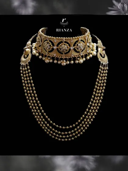 This is a perfect example of how we layer pieces for a complete bridal look. It features a traditional Rajwadi kundan choker paired with a multi-layered pearl and gold jaal necklace, creating a look of unmatched grace and heritage.