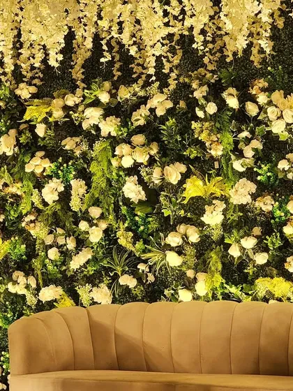 A close-up of our Green Vidhi theme, showing the intricate details of the floral wall and the traditional golden seating.