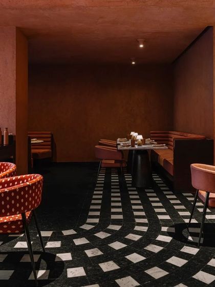 The flowing pattern of the granite floor at Idylll creates a visual path, leading the eye through the space and connecting the different dining areas.