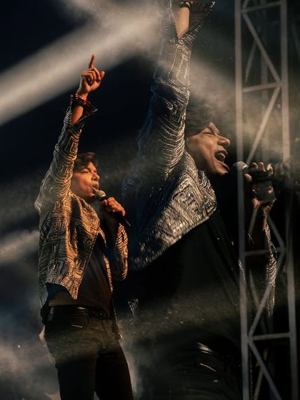 An artistic double-exposure shot capturing the energy of Shaan's performance. We work with professional photographers to document the event.