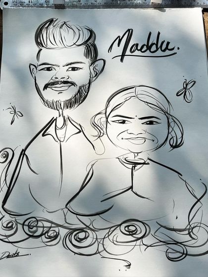 A sweet couple's portrait with the name "Maddu." The flowing lines and decorative swirls add a touch of artistic flair.