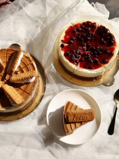 A look at two of our most loved baked cheesecakes. On the left, the popular Lotus Biscoff cheesecake, and on the right, our classic Blueberry cheesecake. Both are baked in-house with a creamy texture that melts in your mouth.