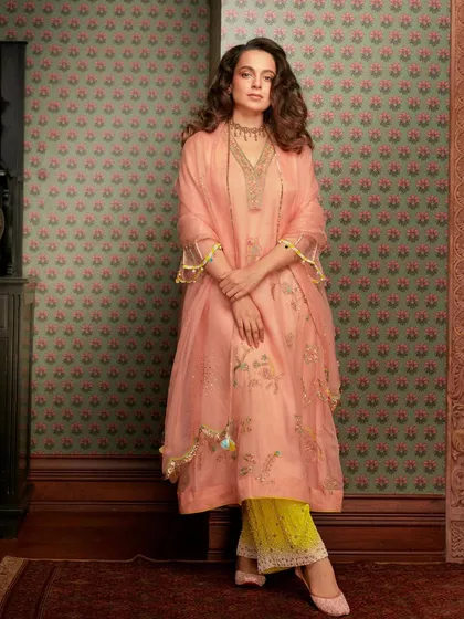 Kangana Ranaut looks absolutely elegant in this peach salwar suit from Raji Ramniq. The delicate embroidery and organza dupatta, paired with a traditional choker, create a look of timeless grace.