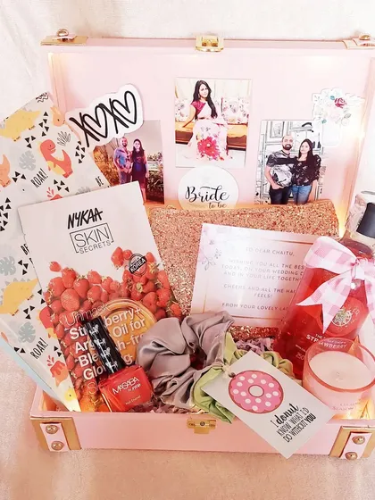 For the fun and quirky bride, this pink trunk is filled with everything she needs for a bit of pre-wedding pampering. It includes skincare, nail polish, a journal, and personal photos to make her smile.