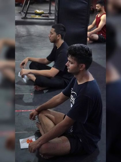 Members sitting in meditation after a workout. This practice is crucial for mental clarity and stress relief, helping you connect your mind and body.