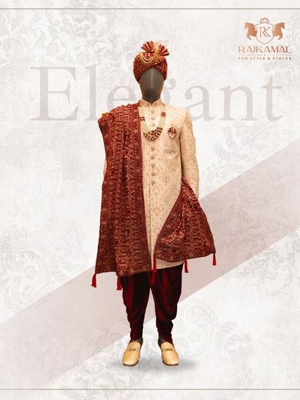 An elegant cream sherwani paired with a rich maroon stole and dhoti pants. This complete look, including the ornate turban, is a perfect example of traditional grace meeting high fashion.