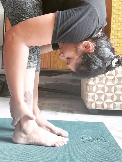 A deep forward fold, or Uttanasana. This pose is a great way to release the spine and calm the mind. Your journey is unique, and that's your superpower.