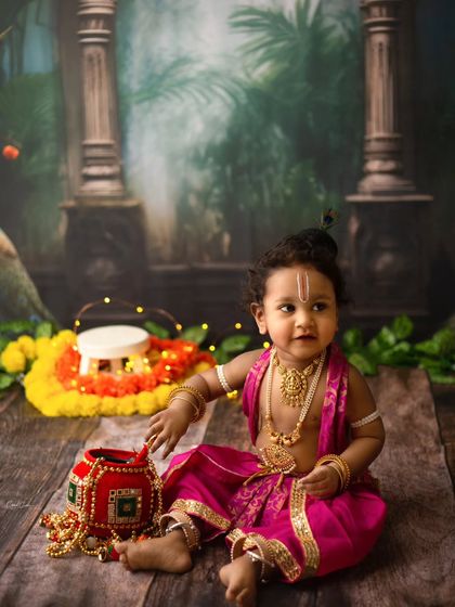 A precious moment with little Krishna reaching for his pot of butter. I love capturing these small, story-telling details in my themed sessions.
