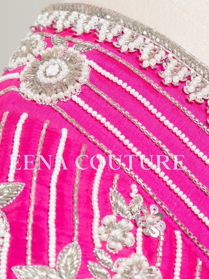 Pretty in pink, this raw silk blouse features intricate pearl and silver thread work in a striped pattern. I added floral motifs and delicate danglers on the sleeves for a touch of playful elegance.