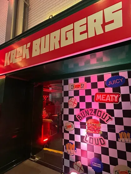 The vibrant entrance to the Krok Burgers launch at Forum Rex Walk. We designed and installed the retro-themed decor, including the checkered backdrop and neon-style signage, to create a fun and immersive brand experience.