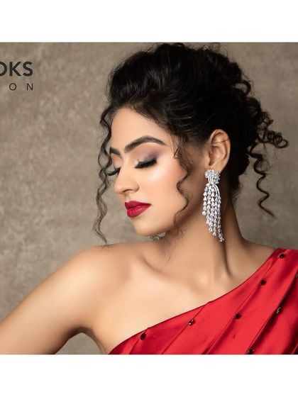 A side profile showcasing the elegant updo and the soft shimmer on the eyelids. This angle highlights the balance between the bold lip and the more subtle eye makeup.
