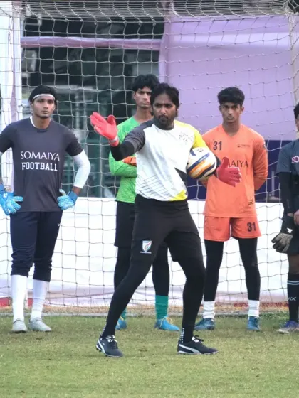 Here, an AIFF Level 2 instructor demonstrates proper ball handling techniques during a specialized goalkeeping clinic. Our workshops focus on providing targeted, hands-on training for specific skill development in sports like football.